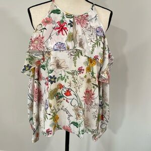 Romantic floral top with delicate ruffle around neck. Shoulder cut out.